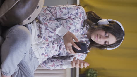 Vertical-video-of-Depressed-young-woman-at-night-texting-on-the-phone.